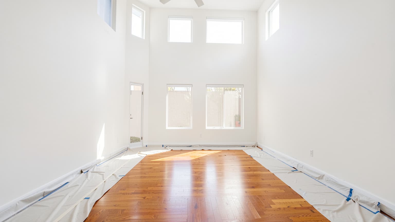 Bright Orange County living room showing smooth walls and trim illustrating the cost to paint interior spaces.